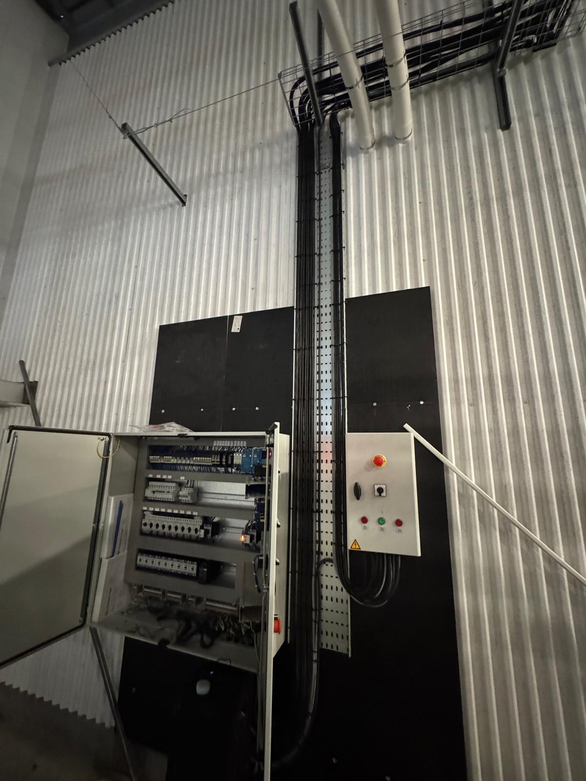 Control panel and vertical containment run in an industrial building