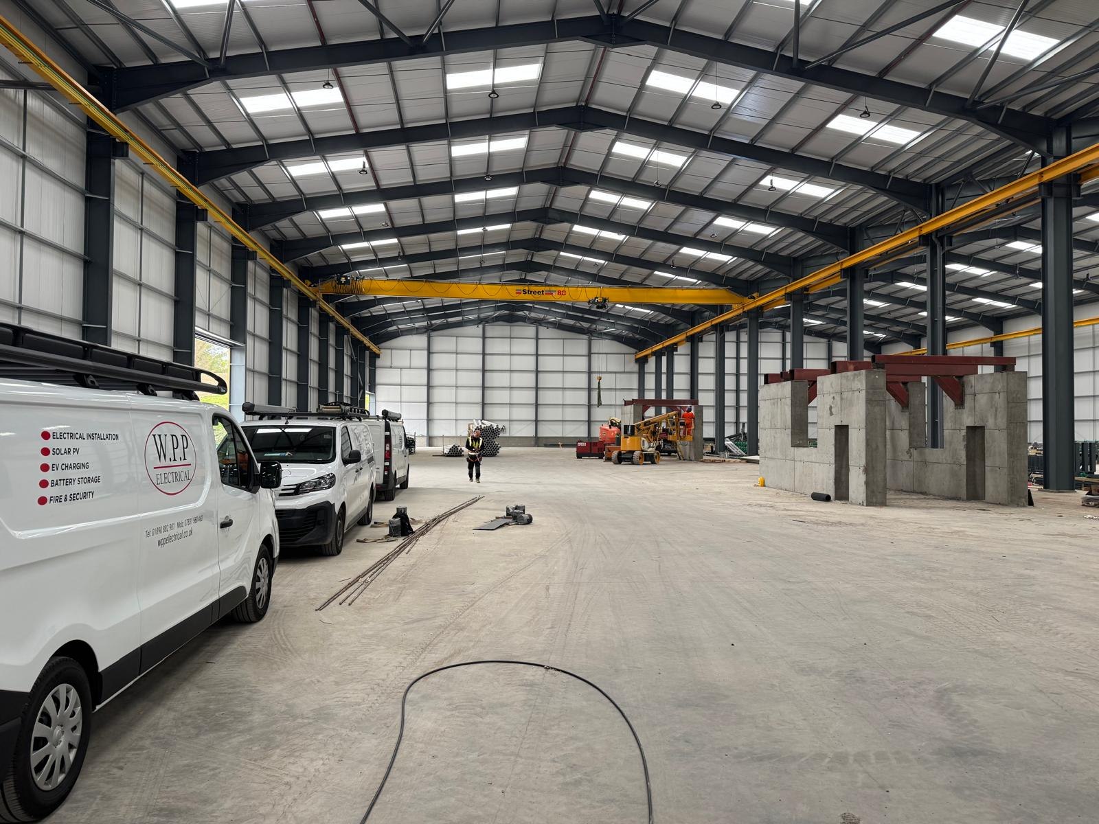 Industrial electrical fit-out inside a new steel-framed warehouse unit