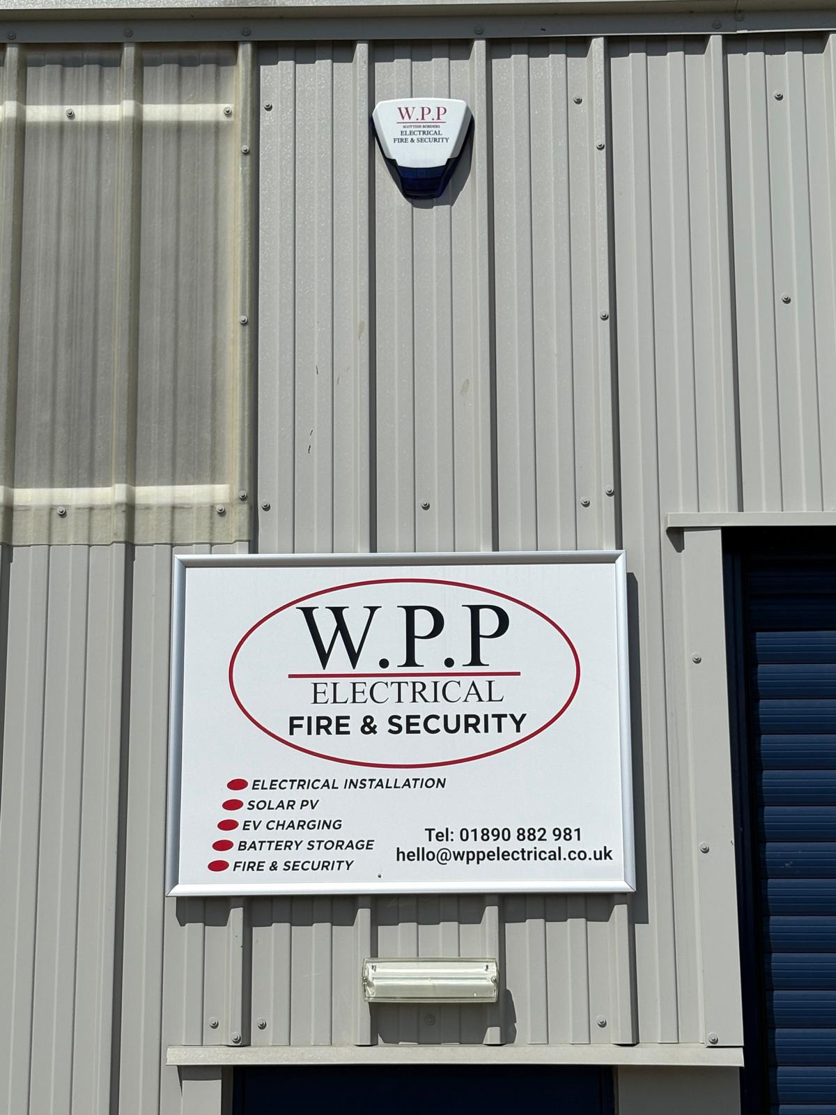 WPP Electrical Fire & Security signage and external alarm sounder on an industrial unit