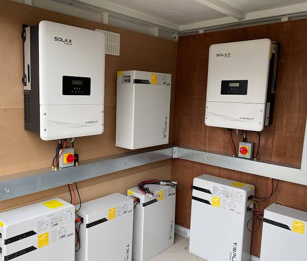 Battery Storage Installation: wall-mounted SolaX inverters and battery storage modules installed in a plant room